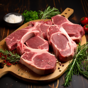 Lamb Leg Chops/Steaks (1lb) on a wooden cutting board with herbs and spices.