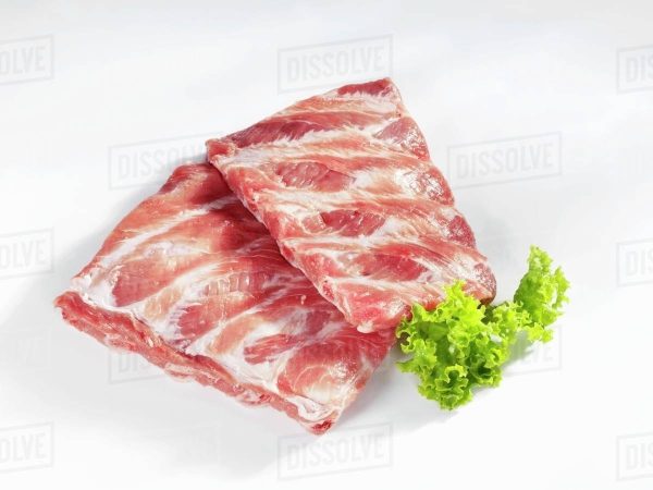 Two pieces of Pork Spare Ribs on a white background royalty-free stock photo.