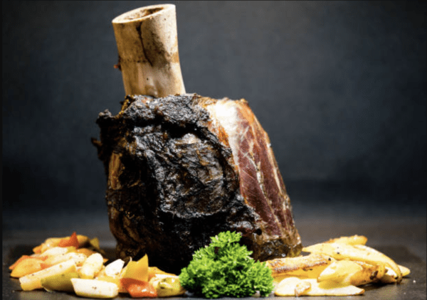 Osso Buco Steak Cooked being served with vegetables